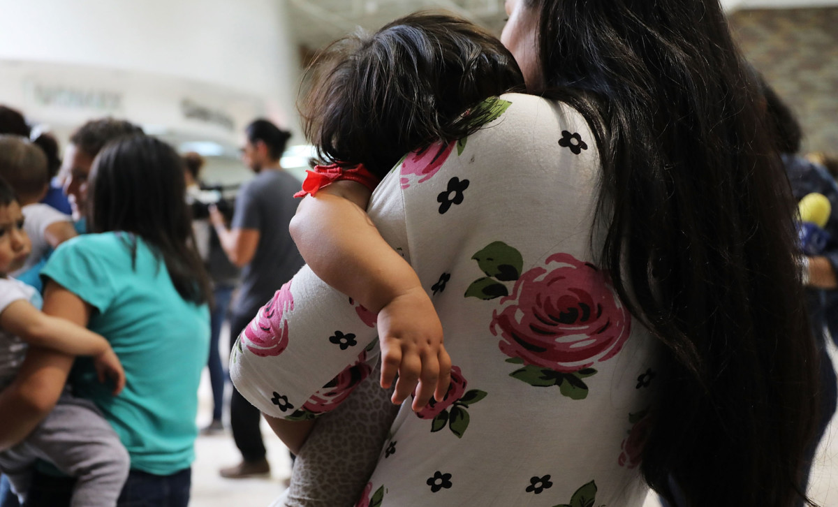 Dozens of women and their children, many fleeing poverty and violence in Honduras, Guatamala and El Salvador, arrive at a bus station following release from Customs and Border Protection on June 22, 2018, in McAllen, Texas.