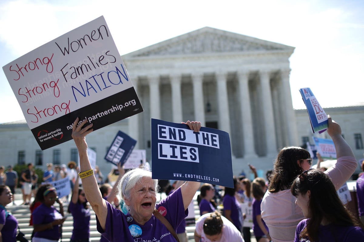 Supporters of reproductive rights protest outside the US Supreme Court as it issues a ruling on a California law related to abortion issues on June 26, 2018, in Washington, DC.