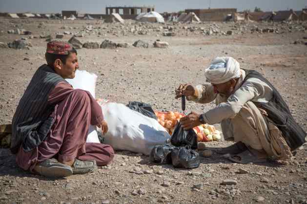 Karim selling onions and potatoes near his tent in Kahdestan.