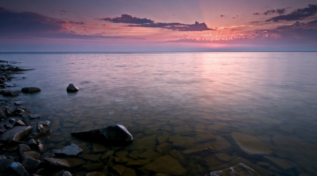 The sun sets along the shore of Door Bluff Headlands County Park, Door County, Wisconsin