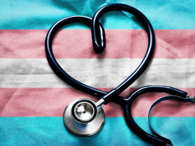 Transgender flag underneath stethoscope