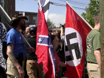 Demonstrators carry Confederate and Nazi flags during the "Unite the Right" rally at Emancipation Park in Charlottesville, Virginia, on August 12, 2017.