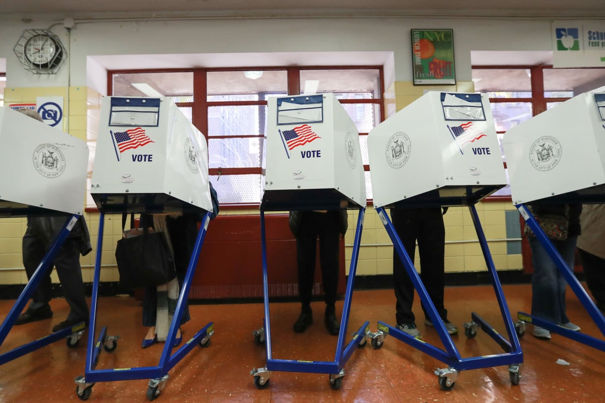 Voters cast their ballots at voting booths at PS198M The Straus School on November 8, 2016 in New York