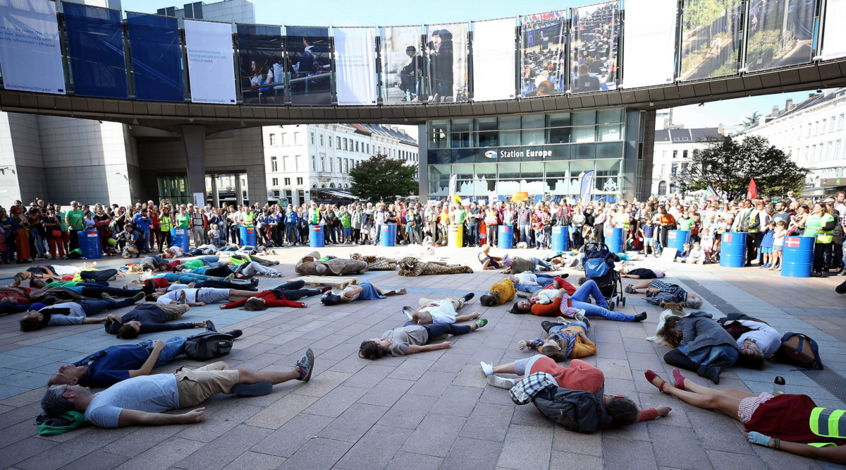 People lie down on the floor in a demonstration to draw attention to global warming and climate change outside of the European Parliament building in Brussels, Belgium on October 6, 2018.
