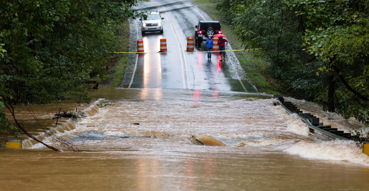 Motorists inspect a road flooded by rain from Hurricane Florence in Waxhaw, North Carolina, September 16, 2018.