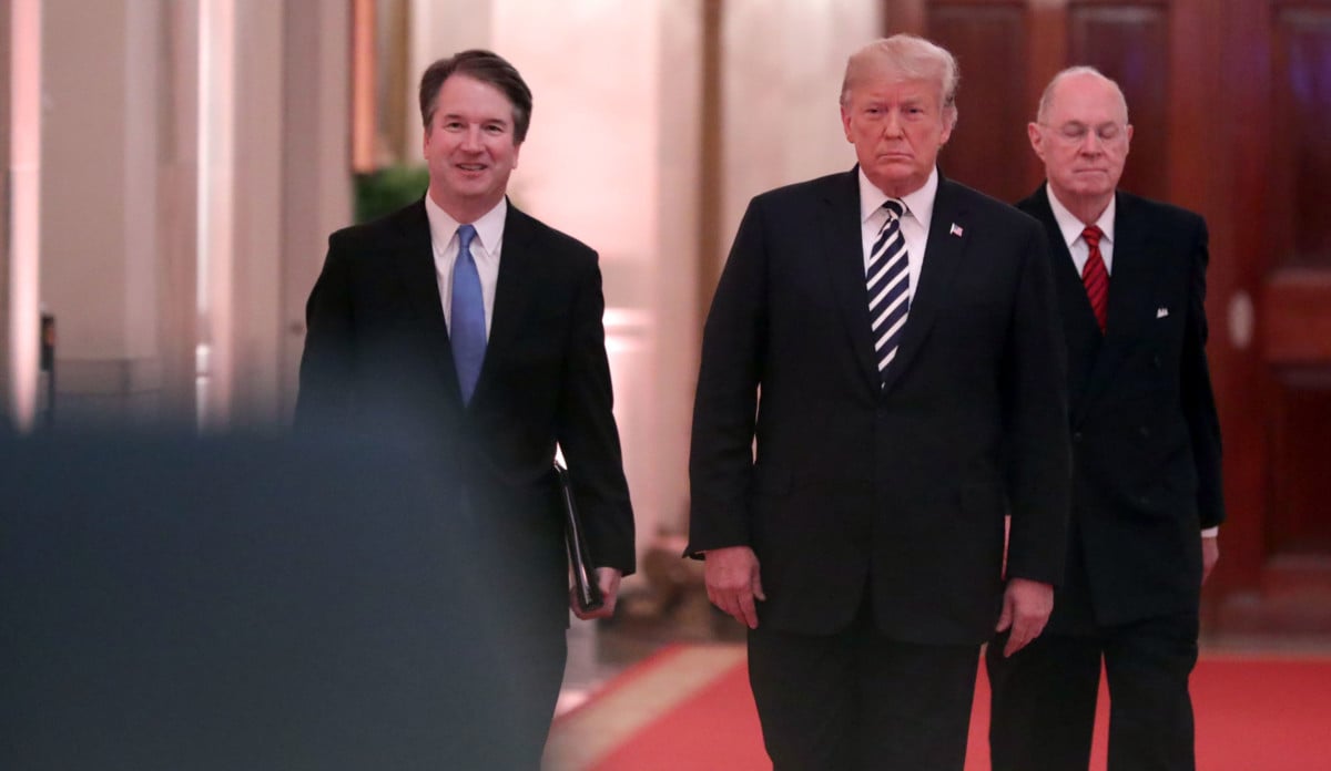 Supreme Court Justice Brett Kavanaugh, President Donald Trump and retired Justice Anthony Kennedy walk into the East Room of the White House for Kavanaugh's ceremonial swearing on October 8, 2018, in Washington, DC.