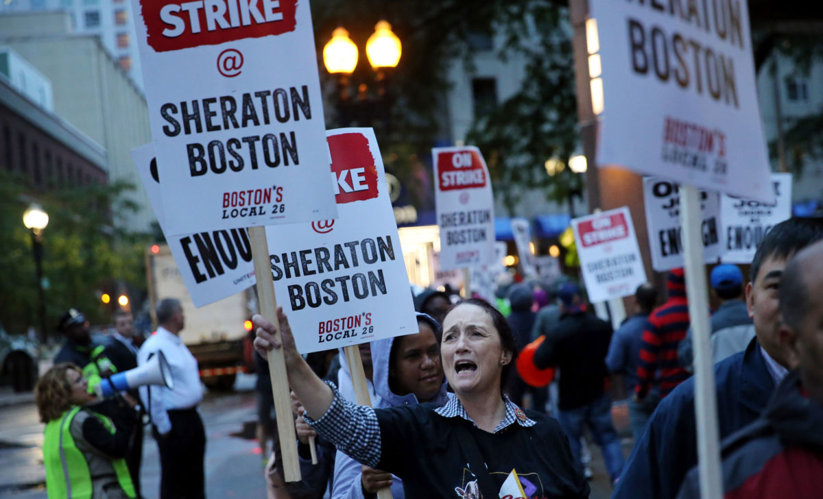Diane Pastos pickets outside the Sheraton Boston by Marriott, where she works as an attendant, in Boston on October 3, 2018.