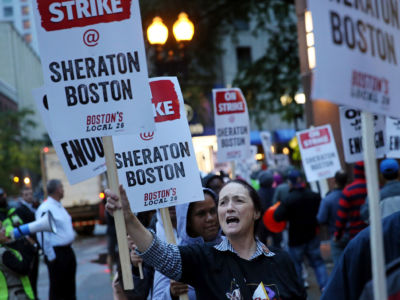 Diane Pastos pickets outside the Sheraton Boston by Marriott, where she works as an attendant, in Boston on October 3, 2018.