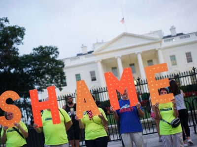 Demonstrators protesting against President Donald Trump are seen in front of the White House in Washington, DC, on August 27, 2018.