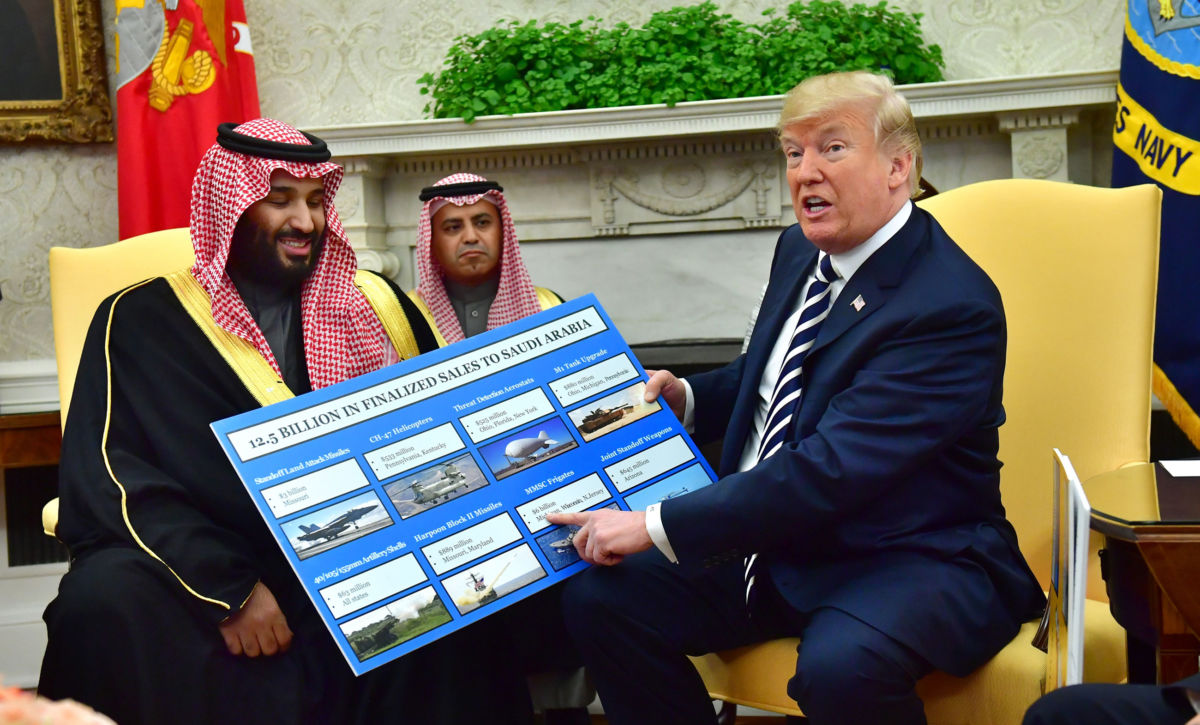 President Trump holds up a chart of military hardware sales as he meets with Crown Prince Mohammed bin Salman of the Kingdom of Saudi Arabia in the Oval Office of the White House on March 20, 2018, in Washington, DC.