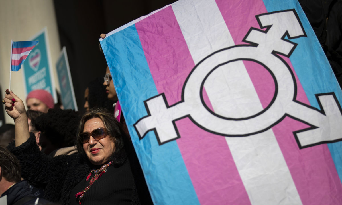 LGBTQ activists and their supporters rally in support of transgender people on the steps of New York City Hall, October 24, 2018, in New York City.