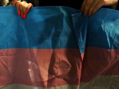 A flag for Transgender and Gender Noncomforming people is held up at a rally for LGBTQI+ rights at Washington Square Park on October 21, 2018, in New York City.