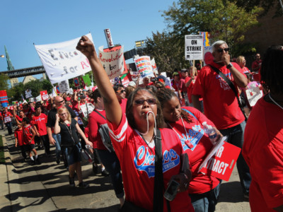 Striking Chicago public school teachers and their supporters march through the streets following a rally at Union Park September 15, 2012, in Chicago, Illinois.