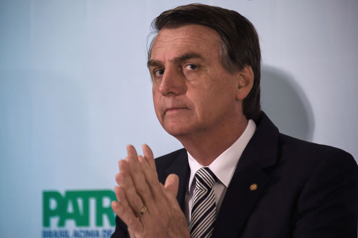 Then Brazilian Deputy Jair Bolsonaro looks on during a press conference he called to announce his intention to run for the Brazilian presidency in the 2018 presidential election, at a hotel in Rio de Janeiro, on August 10, 2017.