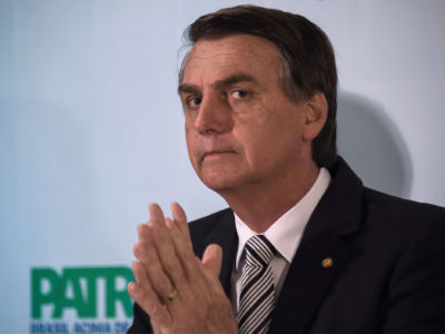 Then Brazilian Deputy Jair Bolsonaro looks on during a press conference he called to announce his intention to run for the Brazilian presidency in the 2018 presidential election, at a hotel in Rio de Janeiro, on August 10, 2017.