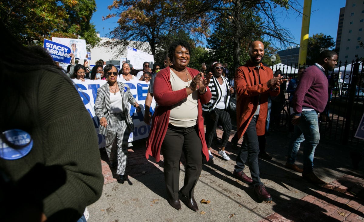 Georgia's Democratic gubernatorial candidate Stacey Abrams and Grammy-winning artist Common lead voters during a "Souls to the Polls" march in downtown Atlanta on October 28, 2018, in Atlanta, Georgia. The march went from Underground Atlanta to the Fulton County Government Center polling station open for early voting.