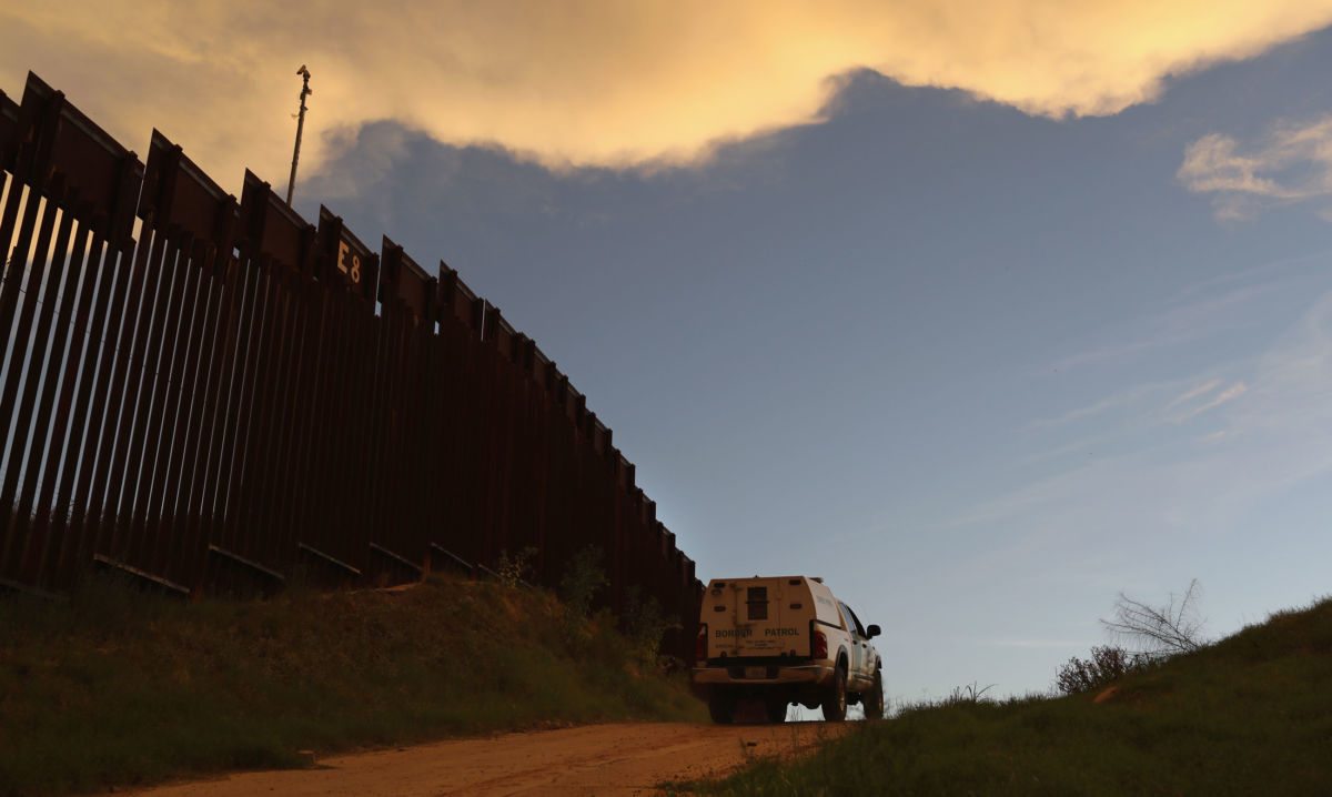 A US Border Patrol vehicle drives along the US-Mexico border at sunset on July 22, 2018, in Nogales, Arizona.