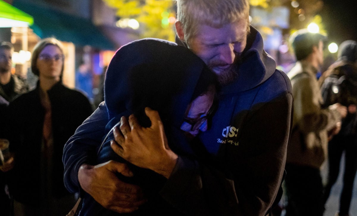 A couple embraces during the "If Not Now When" demonstration in the aftermath of the Tree of Life shootings in Pittsburgh, Pennsylvania.