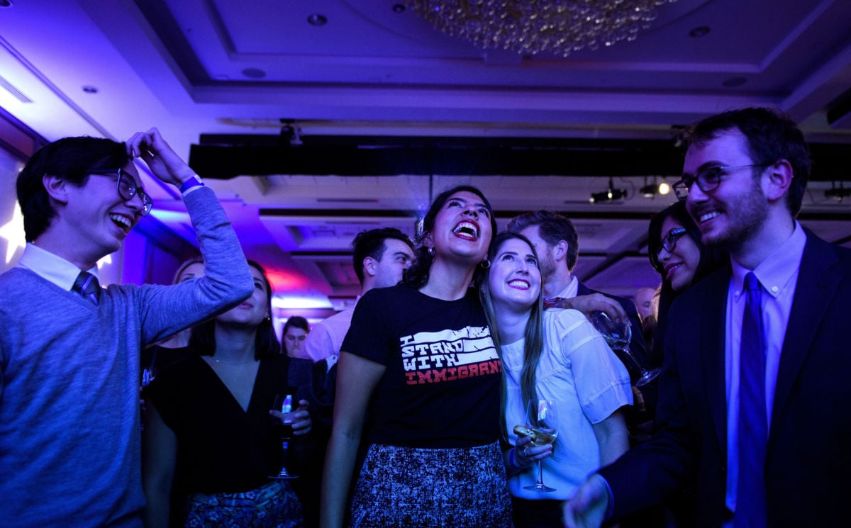 People cheer while watching election results during a midterm election night party hosted by the Democratic Congressional Campaign Committee, November 6, 2018, in Washington, DC.