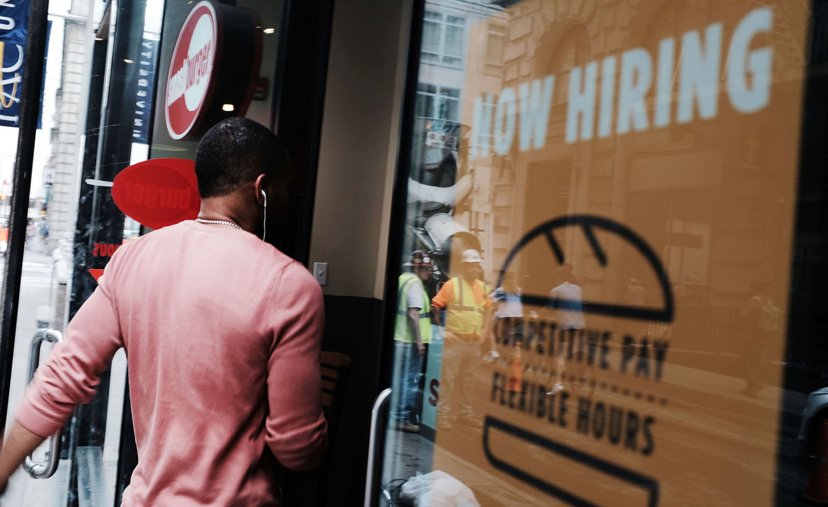 A store advertises that they are hiring in lower Manhattan on June 1, 2018, in New York, New York.
