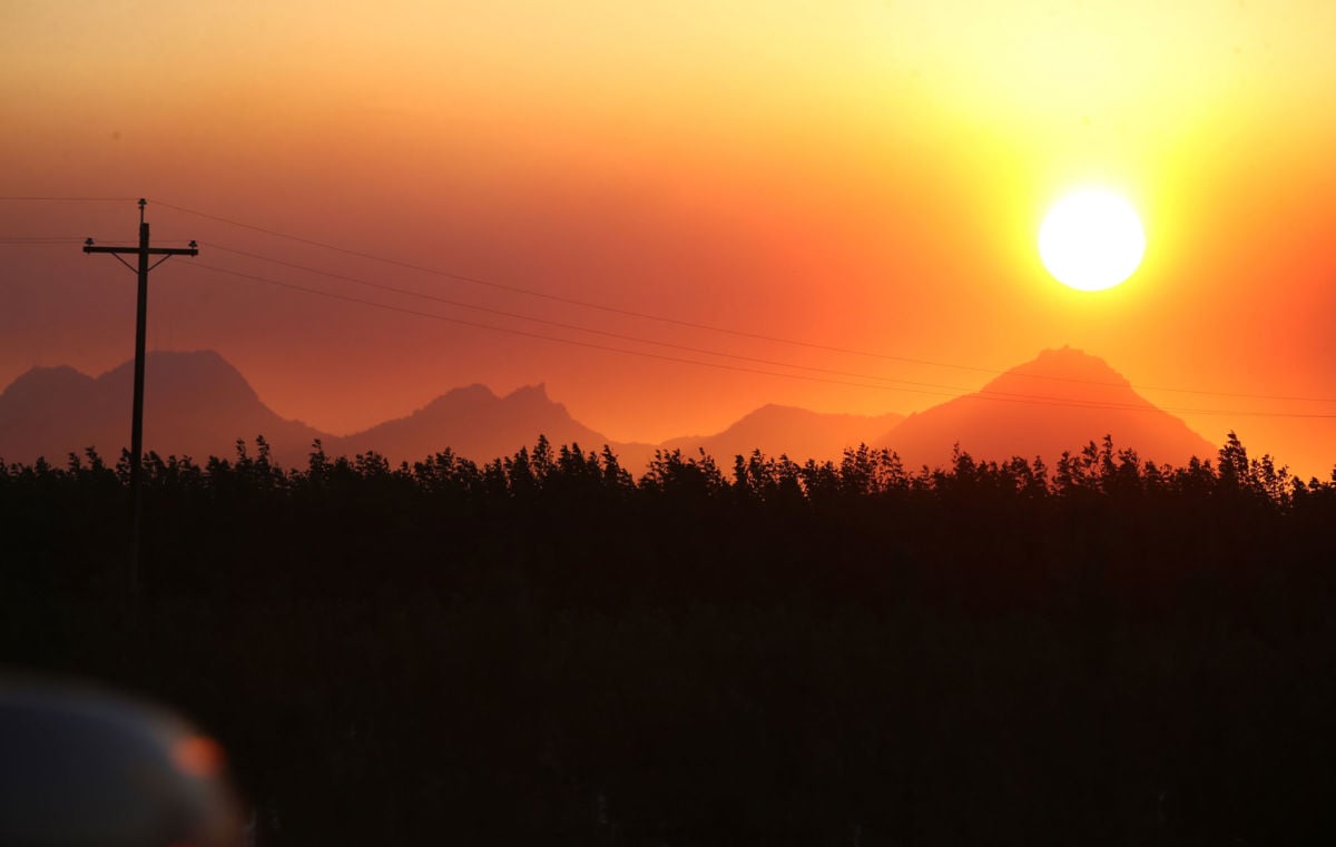 The sun sets behind clouds of smoke from the Camp Fire seen from Highway 70 in Marysville, California, on November 8, 2018.