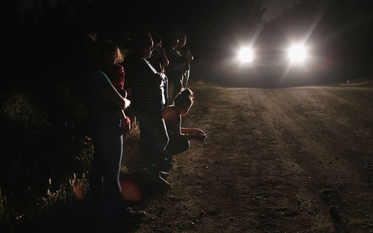 Central American asylum seekers wait for transport while being detained by US Border Patrol agents near the US-Mexico border on June 12, 2018, in McAllen, Texas.