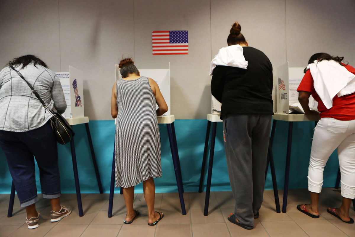 Voters fill out their ballots at a polling place to participate in early voting in California's 25th congressional district on November 4, 2018, in Lancaster, California.