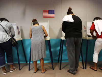 Voters fill out their ballots at a polling place to participate in early voting in California's 25th congressional district on November 4, 2018, in Lancaster, California.