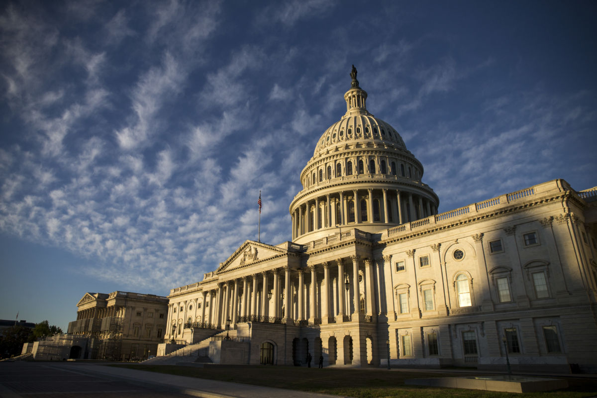 A photo of the US Capitol building in Washington, DC. It's a rectangular white building with a large dome in the center.