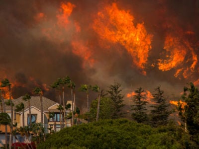 The Woolsey Fire approaches homes on November 9, 2018, in Malibu, California. About 75,000 homes have been evacuated in Los Angeles and Ventura counties due to two fires in the region.