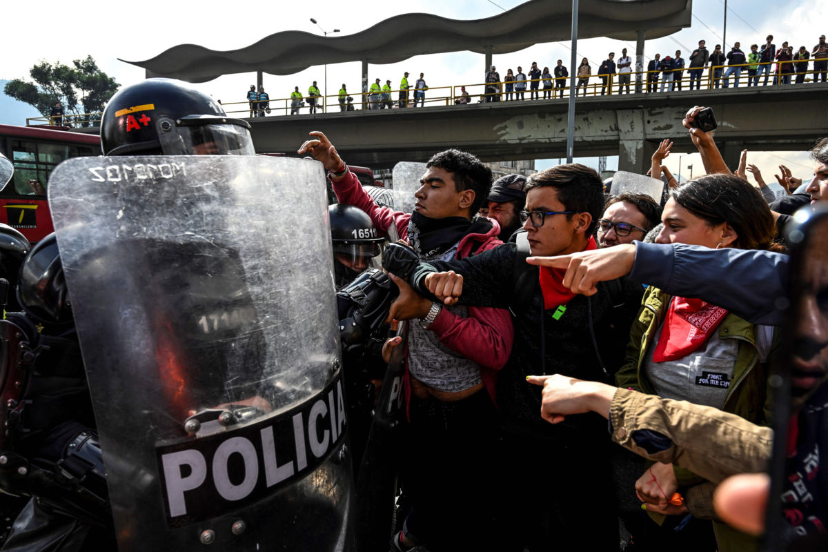 University students struggle with members of the national police during a protest for a budget increase for Colombian tertiary education and against a tax reform bill, in Bogota, Colombia, on November 21, 2018.