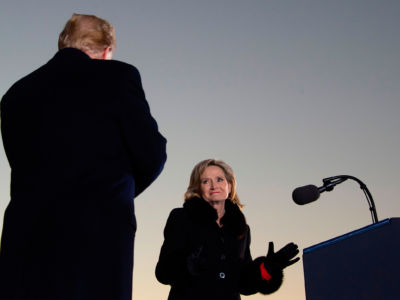 President Trump arrives to deliver remarks as incumbent Republican Sen. Cindy Hyde-Smith looks on at a "Make America Great Again" rally in Tupelo, Mississippi, on November 26, 2018.
