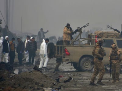 Afghan security forces and investigators gather at the site of a suicide bomb attack outside a British security firm's compound in Kabul, a day after the blast on November 29, 2018.