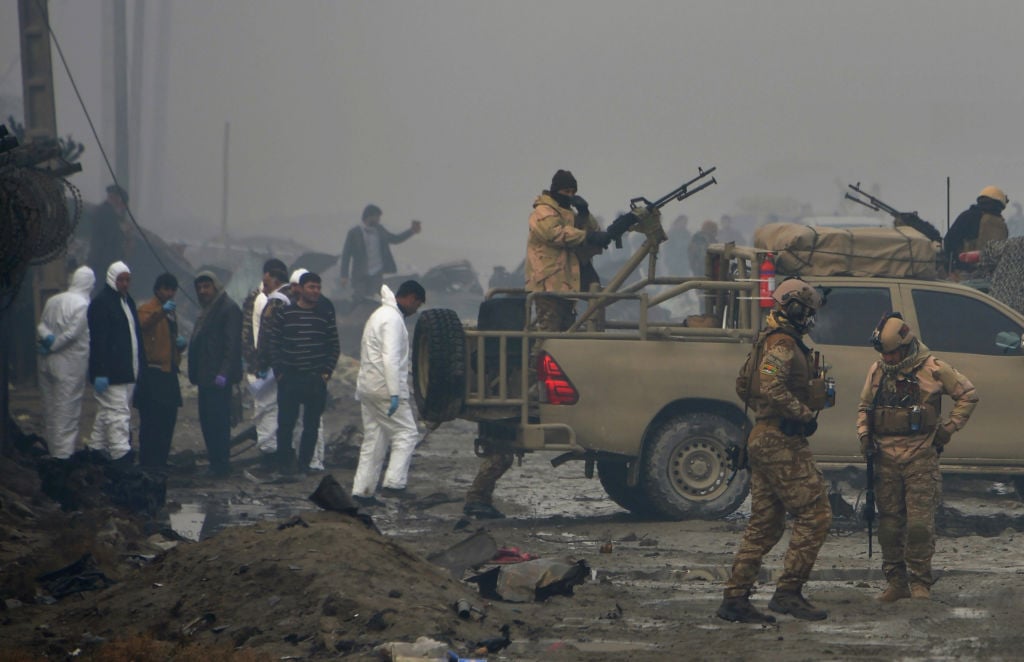Afghan security forces and investigators gather at the site of a suicide bomb attack outside a British security firm's compound in Kabul, a day after the blast on November 29, 2018.
