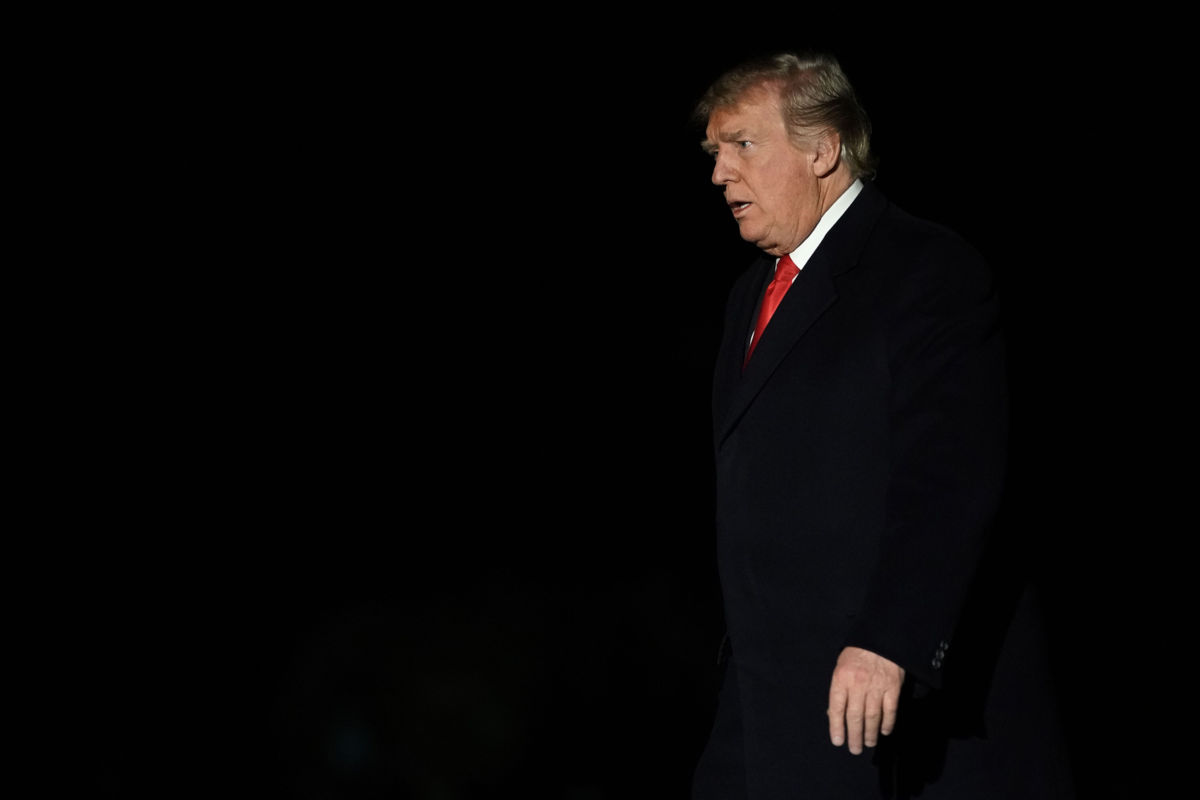 President Trump walks on the South Lawn after returning to the White House in the early morning hours from a trip to Mississippi on November 27, 2018, in Washington, DC.