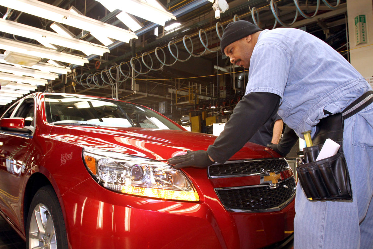 Employee Maurice Vauss inspects the fit and finish of the 2013 Chevrolet Malibu Eco during final inspection on the assembly line in preparation for the Malibu's rollout to dealers across the US at the General Motors Fairfax Assembly Plant January 18, 2012, in Fairfax, Kansas.