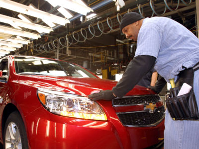 Employee Maurice Vauss inspects the fit and finish of the 2013 Chevrolet Malibu Eco during final inspection on the assembly line in preparation for the Malibu's rollout to dealers across the US at the General Motors Fairfax Assembly Plant January 18, 2012, in Fairfax, Kansas.