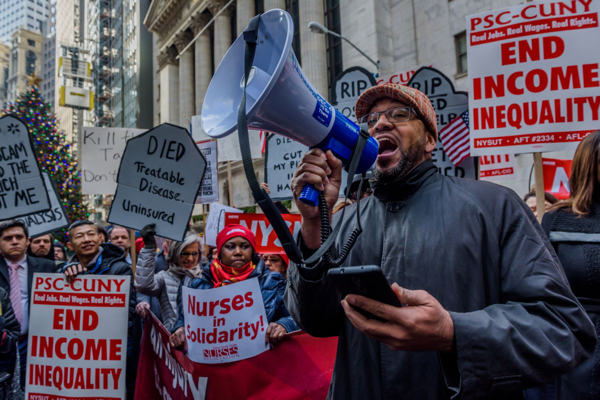 About 500 protesters chanting "Kill the Bill, Dont Kill Us!" fill the street outside the New York Stock Exchange on December 19, 2017, where the resources siphoned from the poor and middle class by the Republican tax bill will be concentrated.