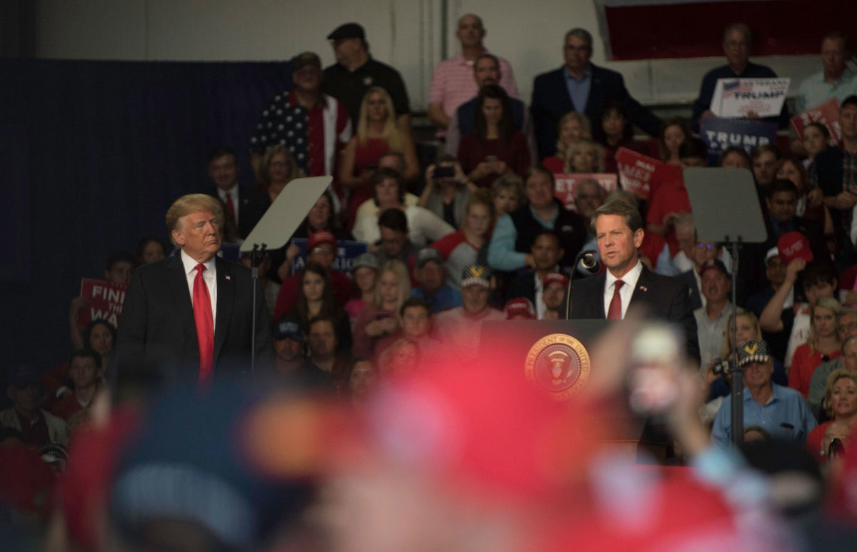President Trump watches as Georgia gubernatorial candidate and Secretary of State Brian Kemp speaks at a "Make America Great" rally in Macon, Georgia, on November 4, 2018.