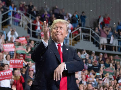 President Donald Trump delivers remarks as fake snow falls at a Make America Great Again rally in Biloxi, Mississippi, on November 26, 2018.