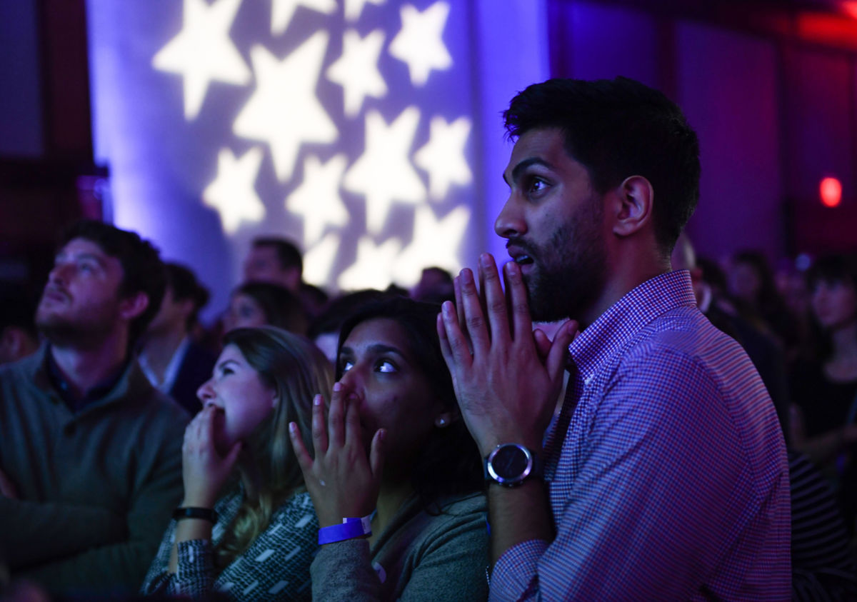 People react to election results at a midterm election night party hosted by the Democratic Congressional Campaign Committee, November 6, 2018, in Washington, DC.