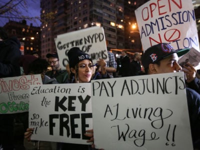 Students hold placards as they stage a demonstration at Hunter College, which is a part of New York City University, to protest ballooning student loan debt for higher education and rally for tuition-free public colleges in New York on November 13, 2015.