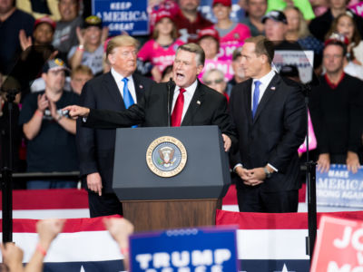Republican congressional candidate Mark Harris addresses the crowd as President Trump listens at the Bojangles Coliseum on October 26, 2018, in Charlotte, North Carolina.