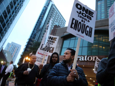 Workers and supporters picket outside the Sheraton Boston by Marriott in Boston on October 3, 2018. Building the world anew under a new social order is the hardheaded realism the working class must face.