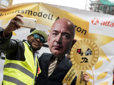 An Amazon warehouse worker shoots a selfie with an activist dressed as Amazon CEO Jeff Bezos during a protest in Berlin, April 2018.