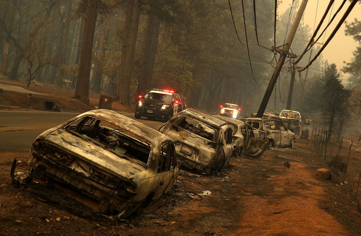 A line of burned out abandoned cars sit on the road after the Camp Fire moved through the area on November 9, 2018, in Paradise, California.