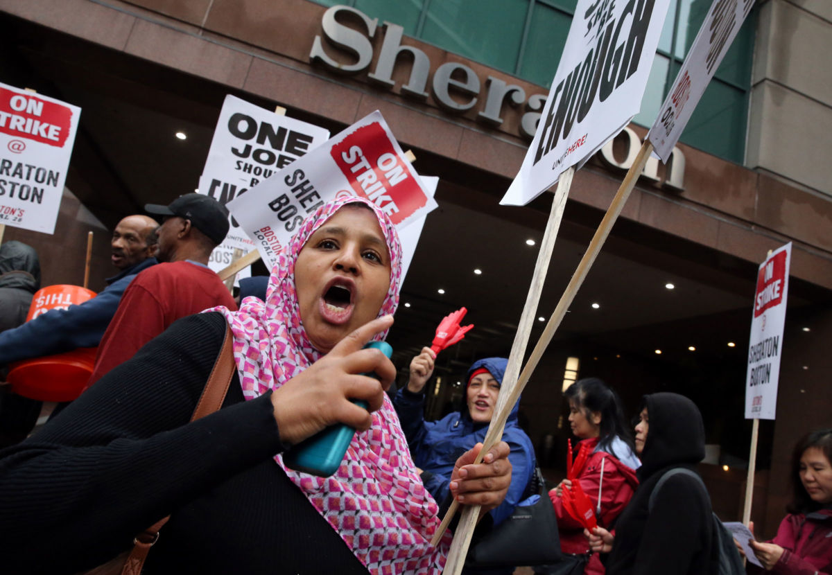 Hawa Diallo pickets outside the Sheraton Boston by Marriott, where she works in housekeeping, in Boston on October 3, 2018.