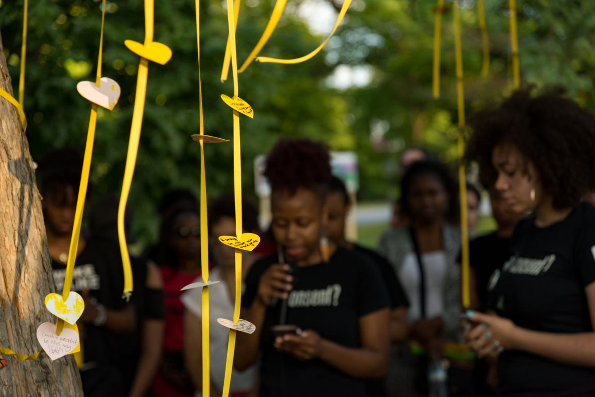As part of the Chicago Park District's Night Out in the Parks, A Long Walk Home's Girl/Friends artists and activists speak in front of the "Healing Tree," a special tribute to the living memory of Rekia Boyd and recently missing Black girls, on July 26, 2018..