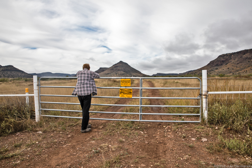 Mark Glover at the entrance to a Trans-Pecos pipeline transfer station a quarter mile from their home.