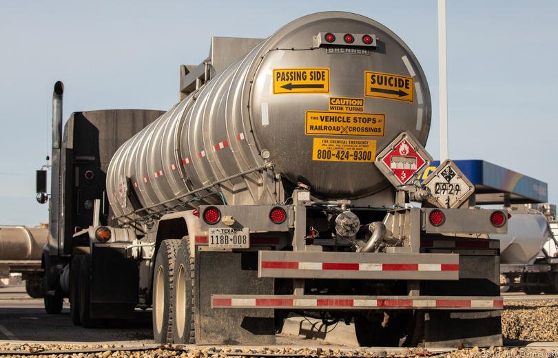 Fracking industry truck in Texas’ Permian Basin with warning signs for other vehicles.